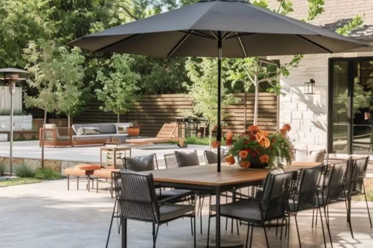 a concrete patio with umbrella and dinning area