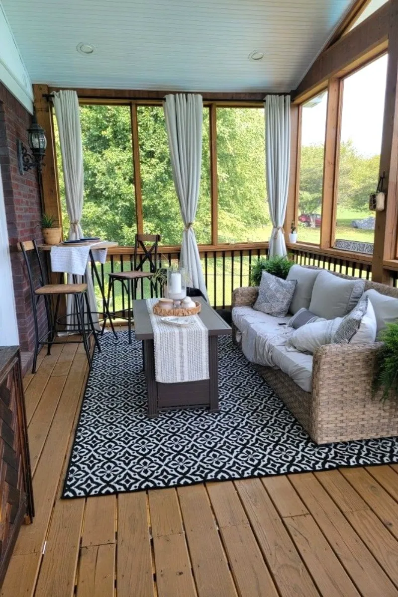 screen porch ideas with curtains, rug, and wooden floor
